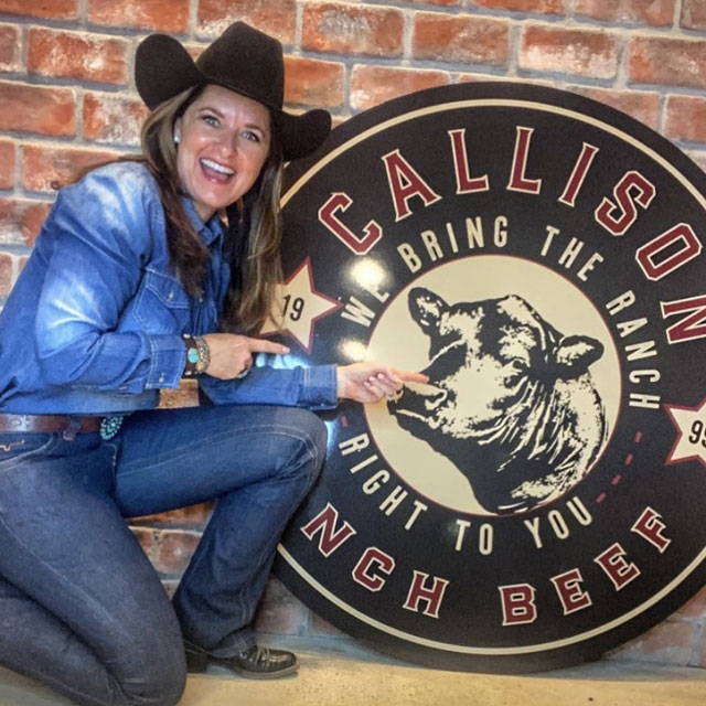 Nikki posing with the Callison Ranch Beef Sign at the market.